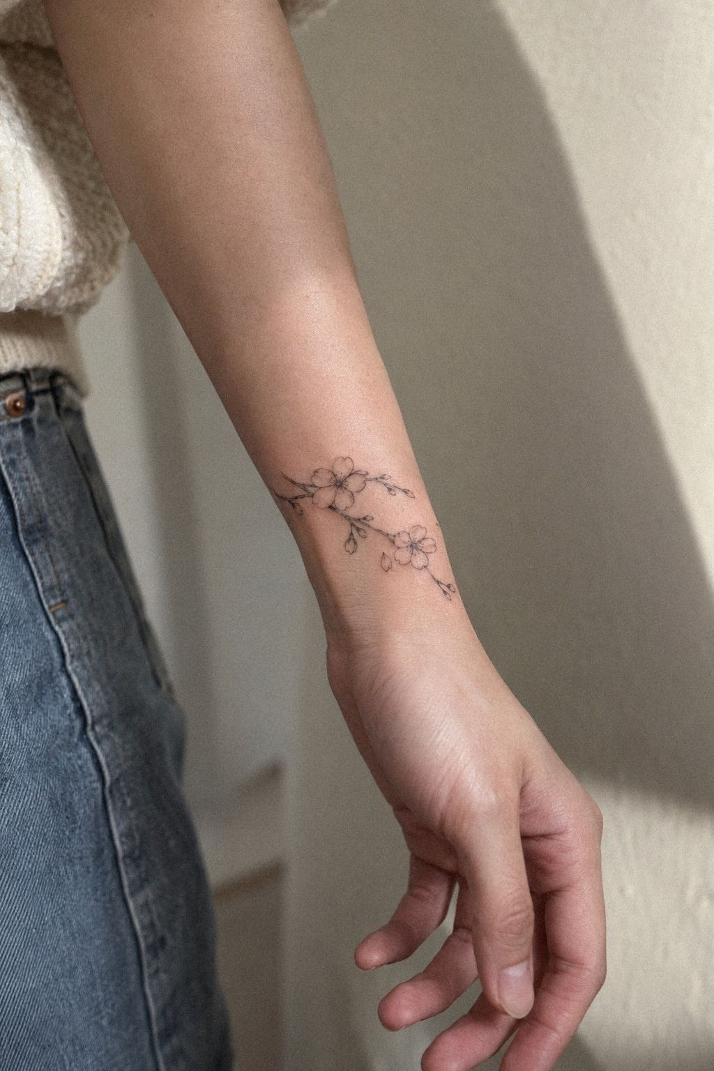 Start Small: A Delicate Cherry Blossom Wrist Tattoo